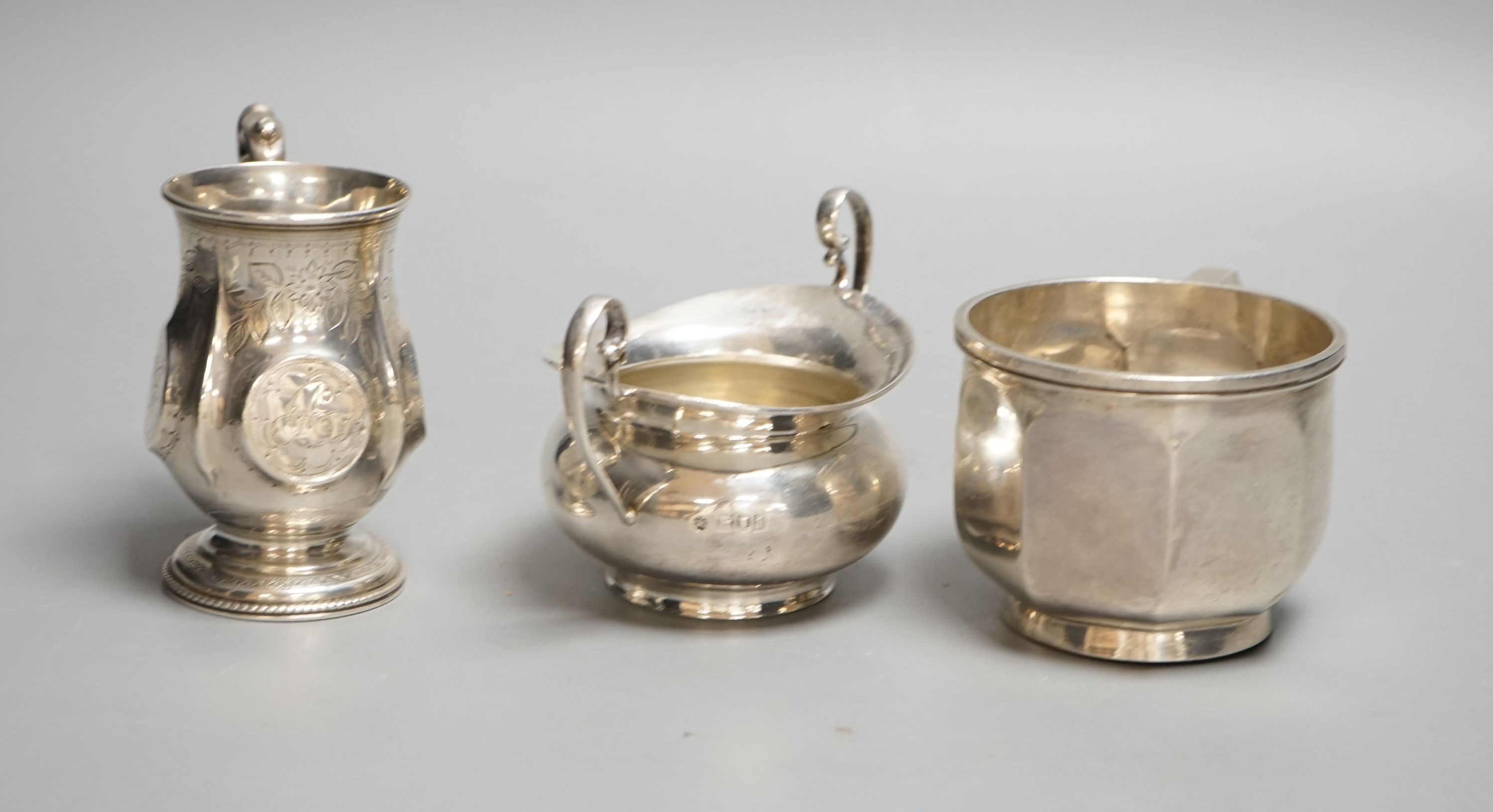 A Victorian silver christening mug, Birmingham, 1874, a later silver mug and a two handled sugar bowl